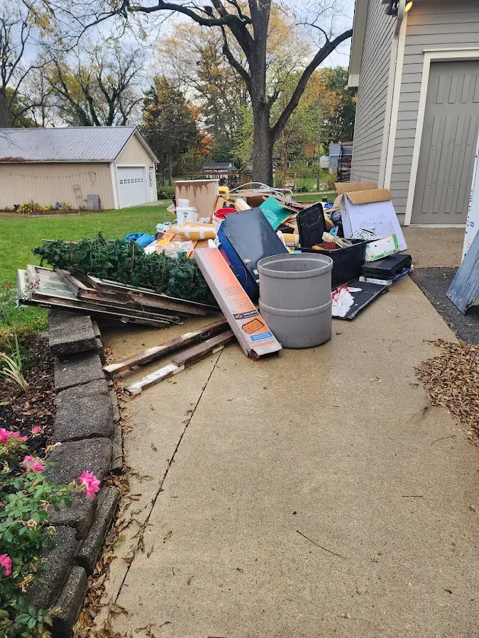 Dumpster being loaded with debris for Estate Cleanout Dumpster Rental in Georges